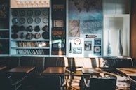 A cozy lobby area decorated with vintage maps and clocks reflecting the journey theme.