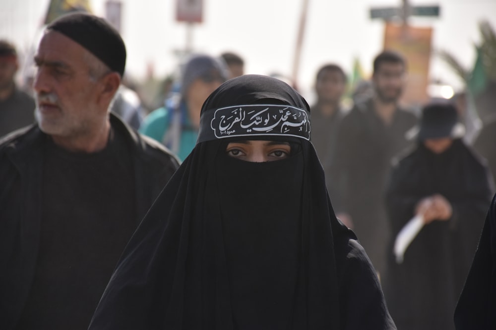 group of people in black walking