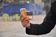 Juice cartons of mango and orange flavors stacked with eco-friendly straws nearby.