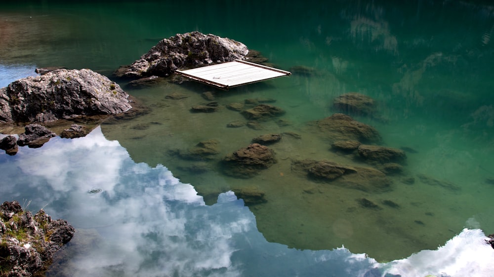 white boat floating on water with ice landscape photography