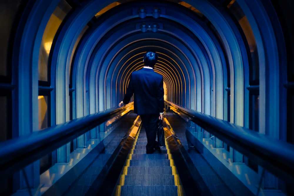 man standing on escalator