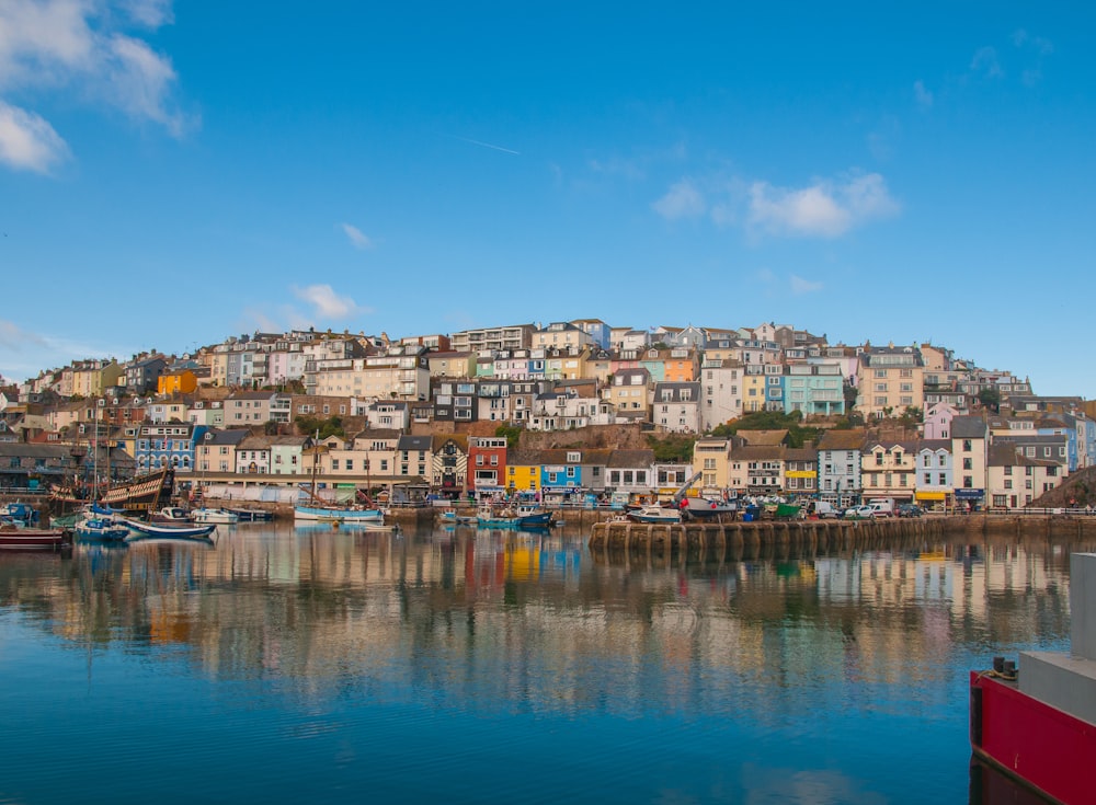 multicolored color concrete buildings near body of water