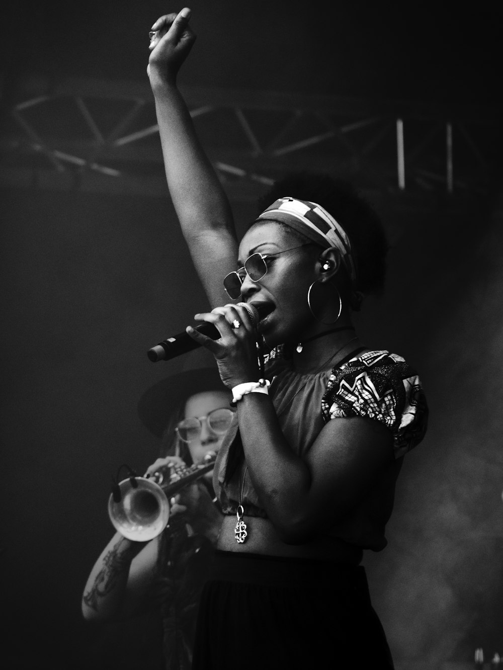 grayscale photography of woman holding microphone