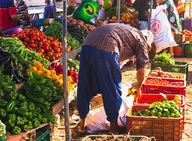 person surrounded by vegetables