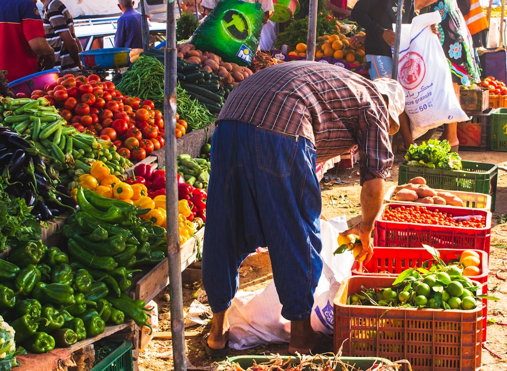 person surrounded by vegetables