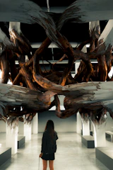 A large-scale wooden structure sculpture displayed in a New York City gallery.
