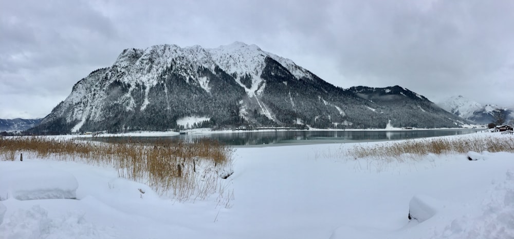 grey mountain near body of water during daytime