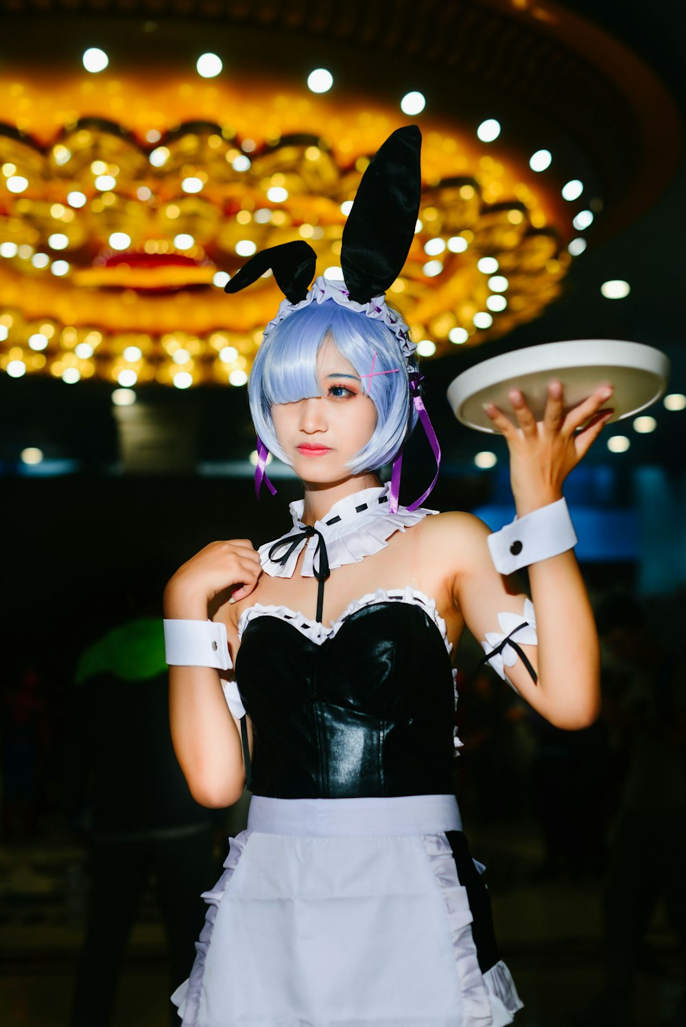 woman in maid costume holding platter on hand