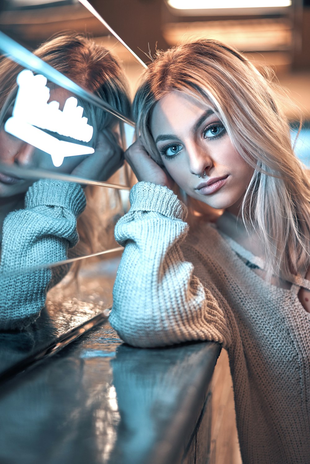 woman leaning on marble-top surface