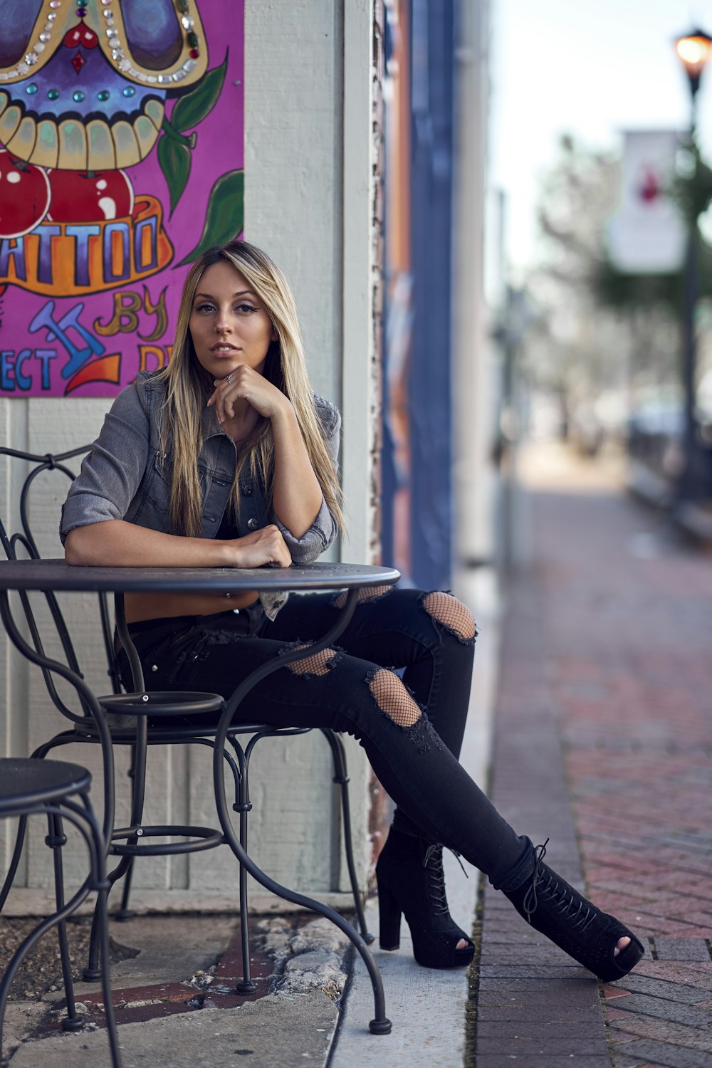 woman sitting on chair while leaning table