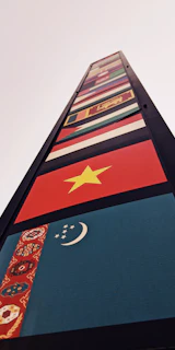 Flags of Saudi Arabia, UAE, Canada, USA, Australia, and Europe surrounding a glowing earth with connected financial lines.