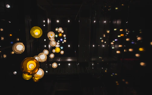 Multi-globe mini pendants hanging in a cluster, casting playful light patterns.