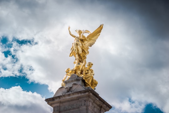 gold human statue during daytime in Victoria Memorial United Kingdom