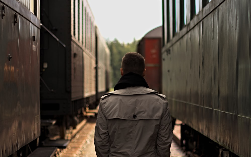 man standing between tanks