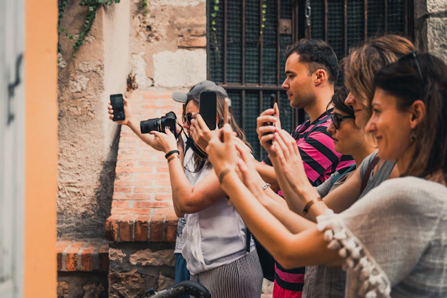 A group of travelers capturing memories near the iconic Braga street in Bandung.