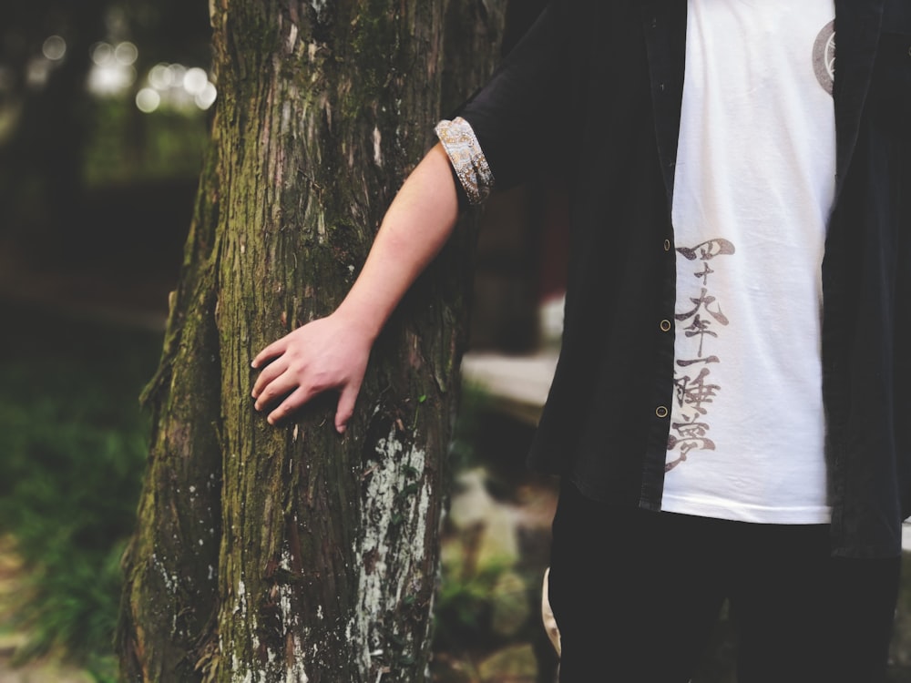 person touching tree trunk