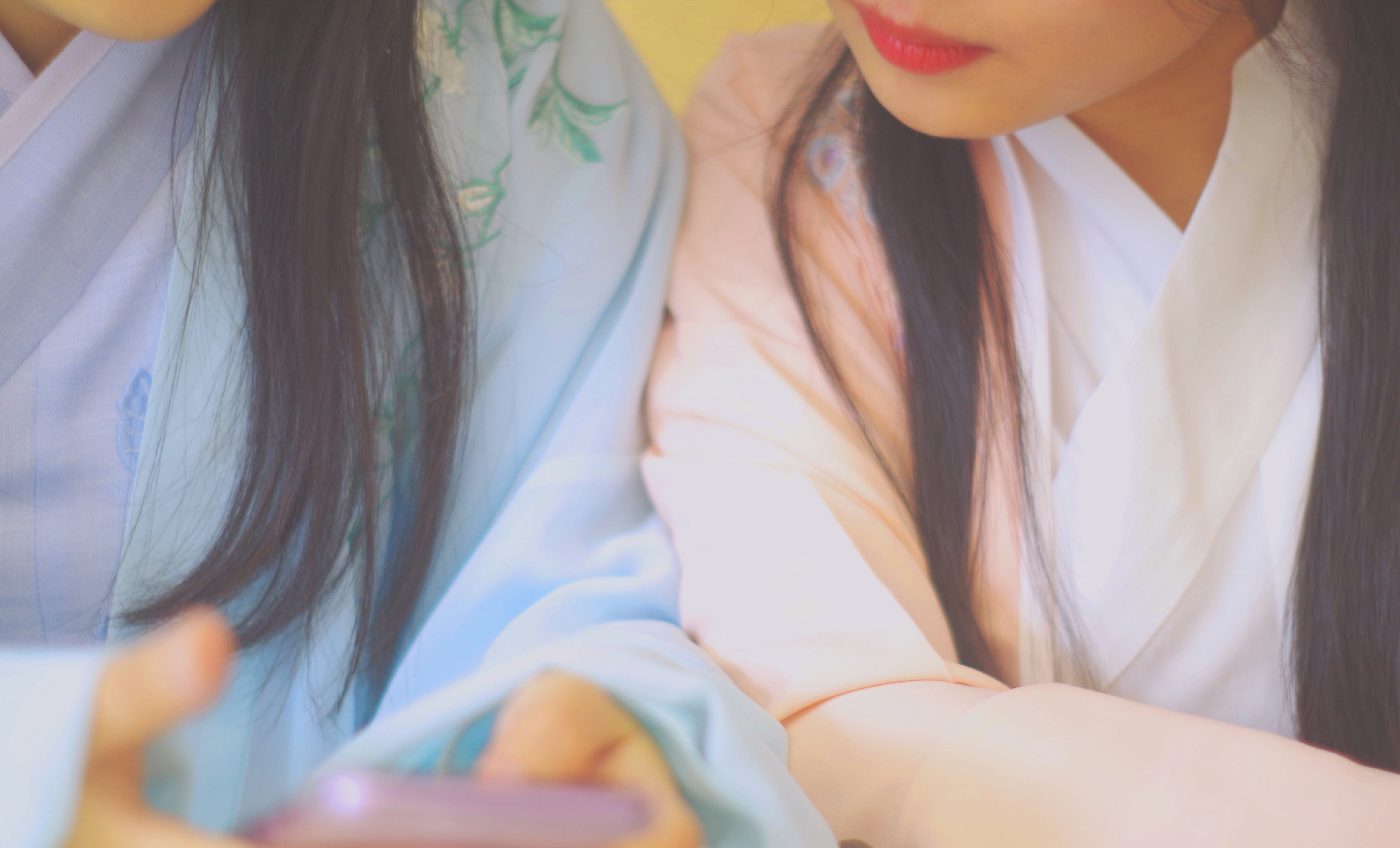 two women looking at smartphone
