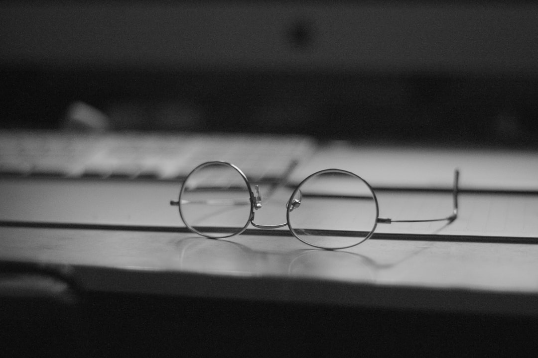 gray eyeglasses on top table