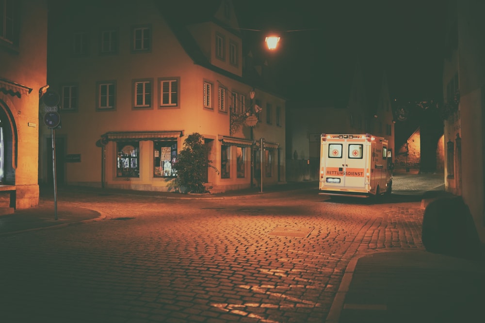 white and orange bus on road during night time
