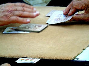 A live casino dealer dealing cards at a professional gaming table.