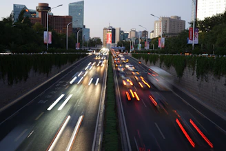 A busy urban road with fresh asphalt and modern street lighting at dusk.