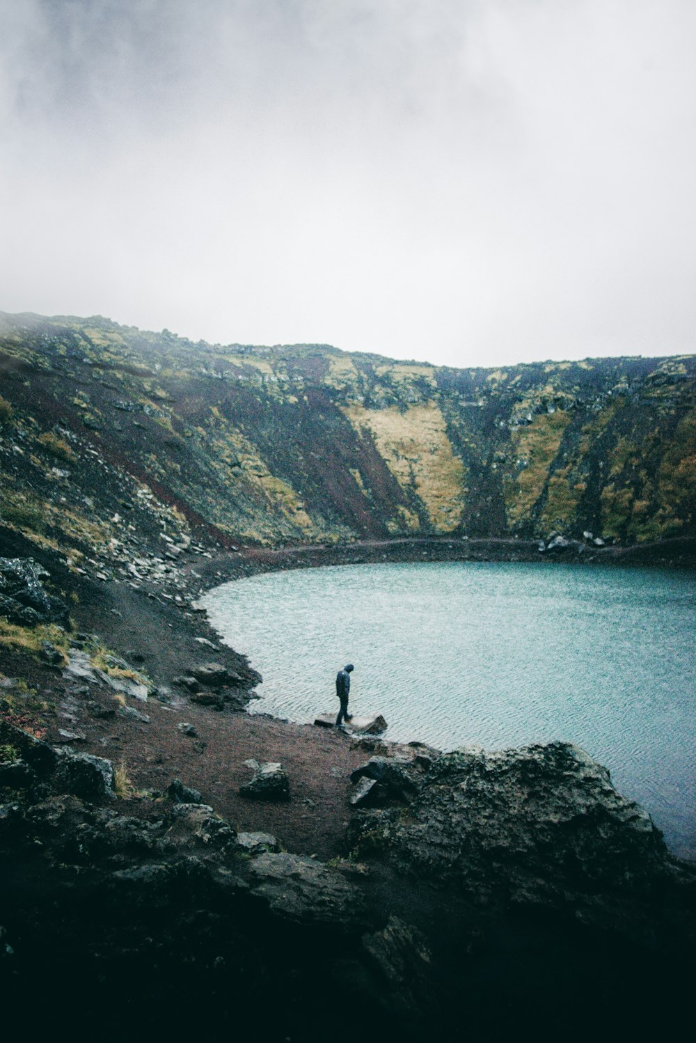 person standing in front of body of water