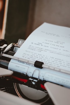 Vintage typewriter with a partially typed newspaper article.