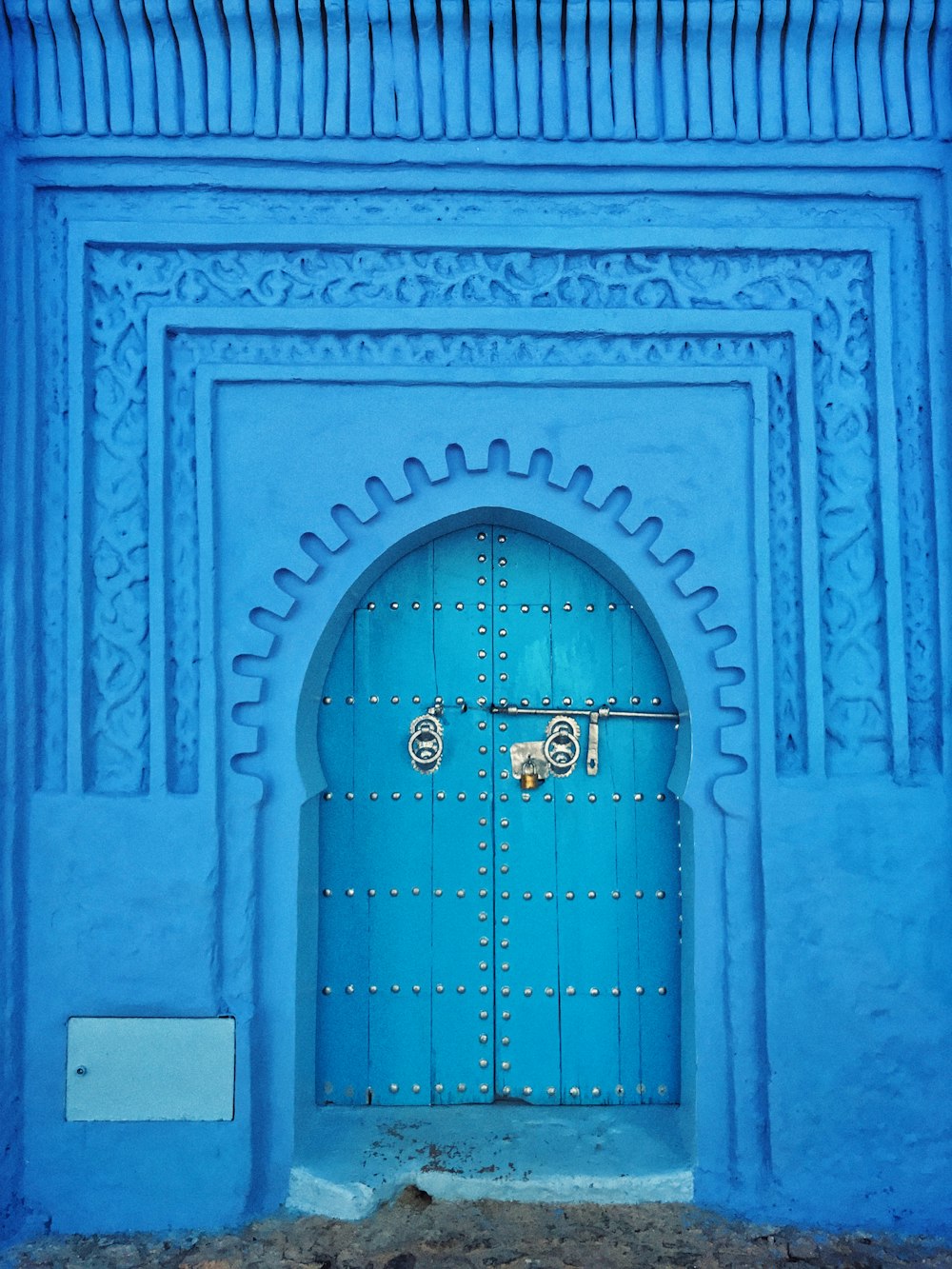 blue painted wall and door at daytime