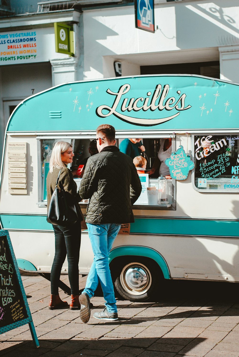 man and woman standing in front of food truck