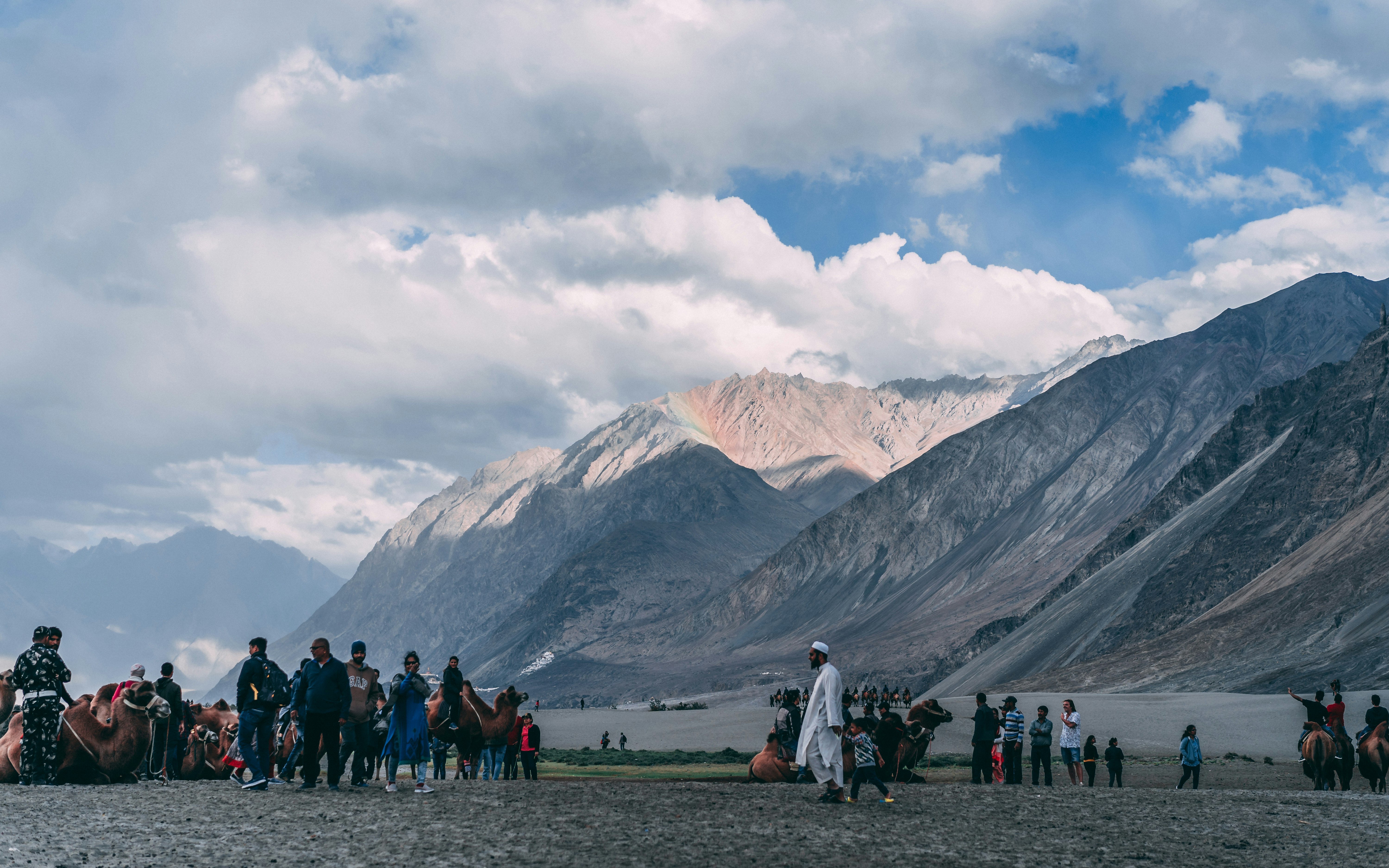 people standing near mountain