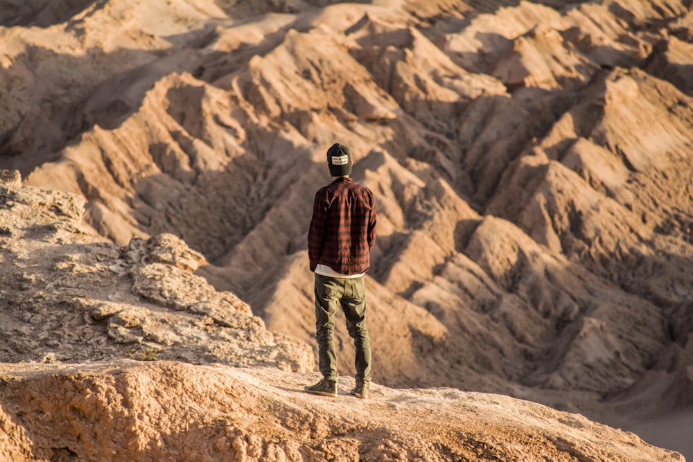 man standing on mountain range during daytime