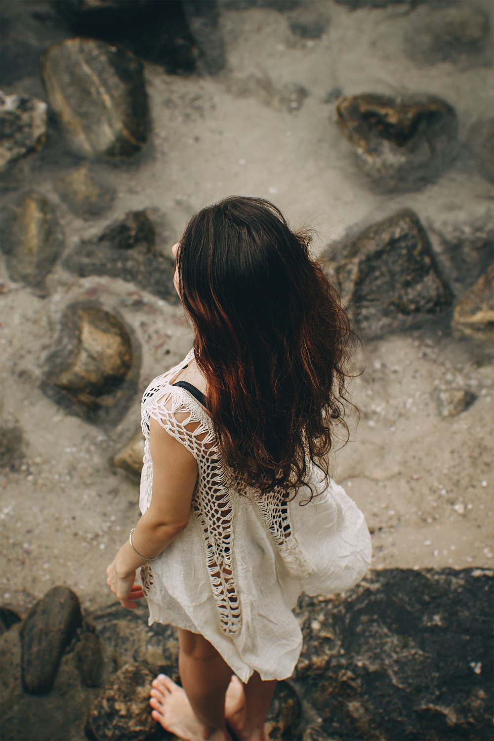 woman standing on rocks