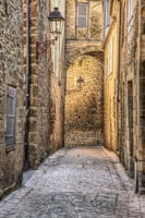 Historic cobblestone alley bathed in golden afternoon light, inviting exploration.