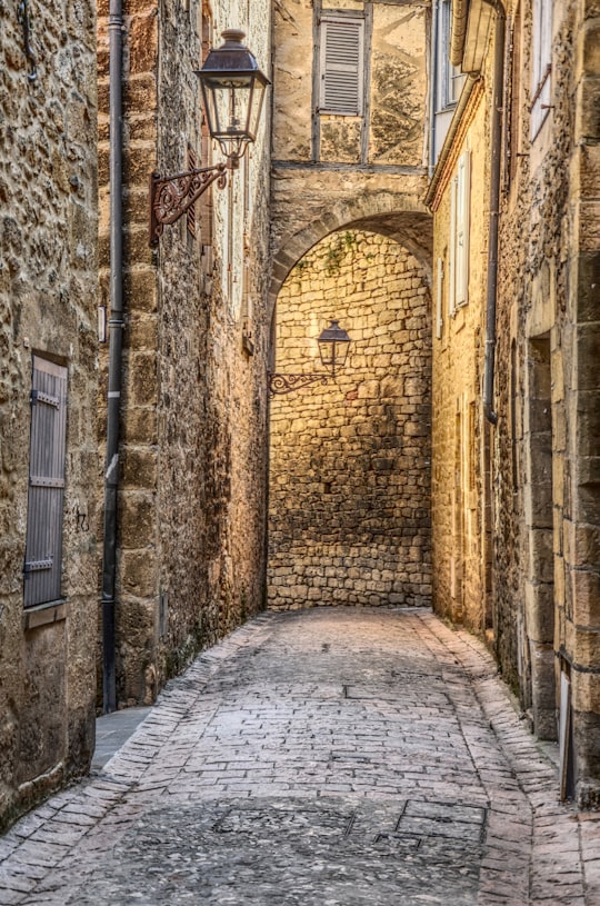 narrow pathway between concrete brick buildings in Sarlat-la-Canéda France
