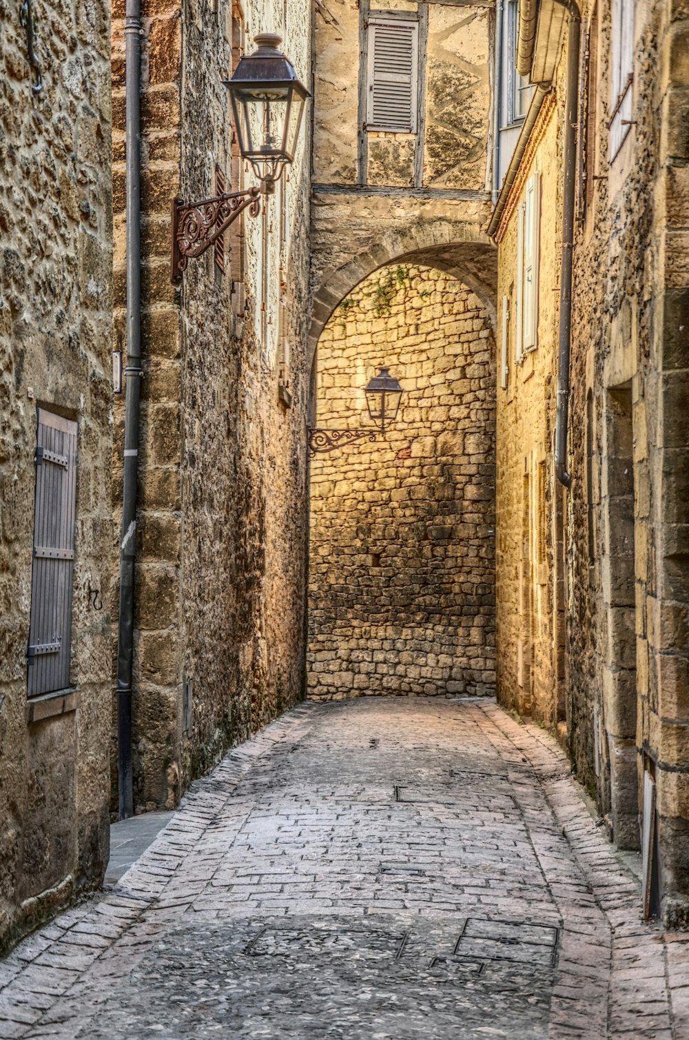 narrow pathway between concrete brick buildings
