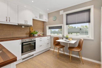 Kitchen Remodel in a new home with new cabinets with windows and new paint with tile floors. 