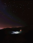 A software startup team brainstorming under an ethereal, star-lit sky.