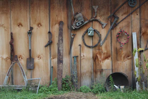 Photo of a wall-mounted montage made from discarded tools and metal scraps, arranged creatively.