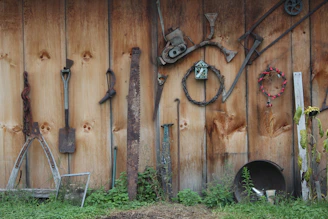 Photo of a wall-mounted montage made from discarded tools and metal scraps, arranged creatively.