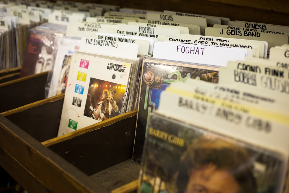 assorted-title albums on brown wooden organizer