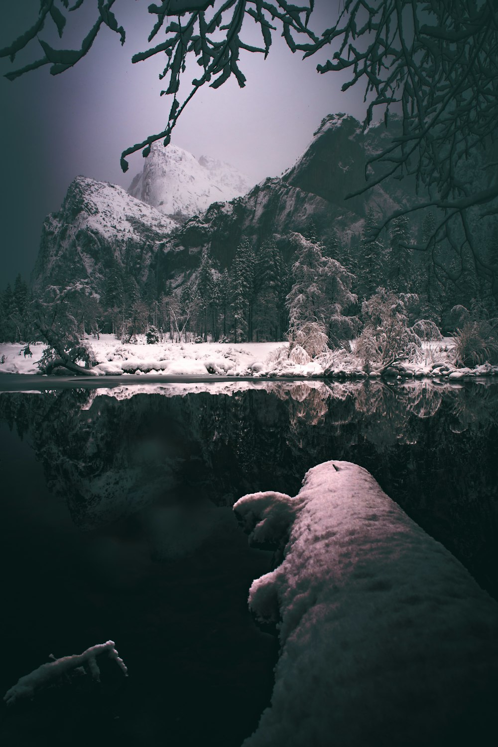 reflection photography of mountain range covered with snow