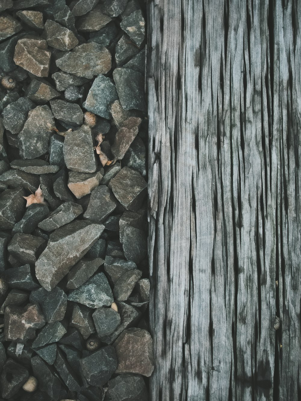a close up of rocks near a wooden post