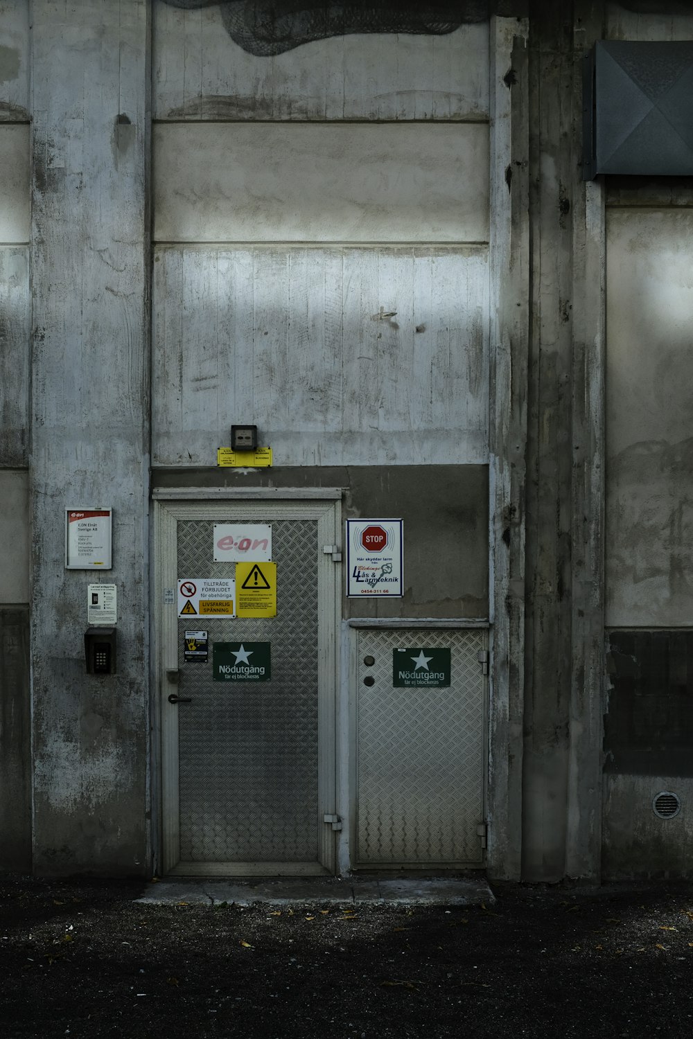 a building with two doors and a sign on the door