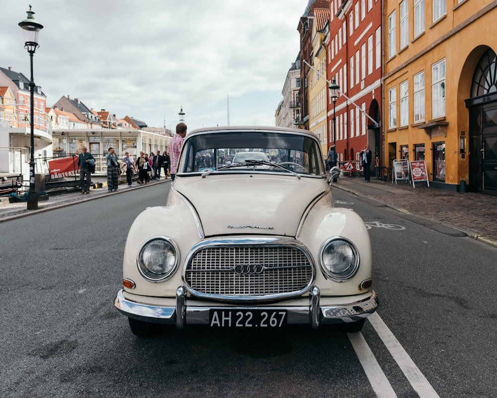 classic white Audi vehicle on asphalt road