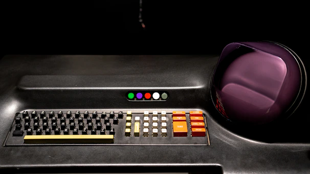 Close-up of an early fax machine control panel with blinking lights and mechanical buttons.
