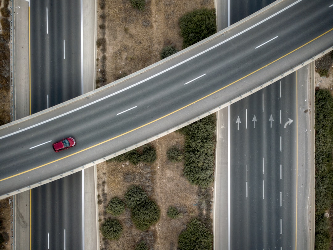 aerial photo of red vehicle on road