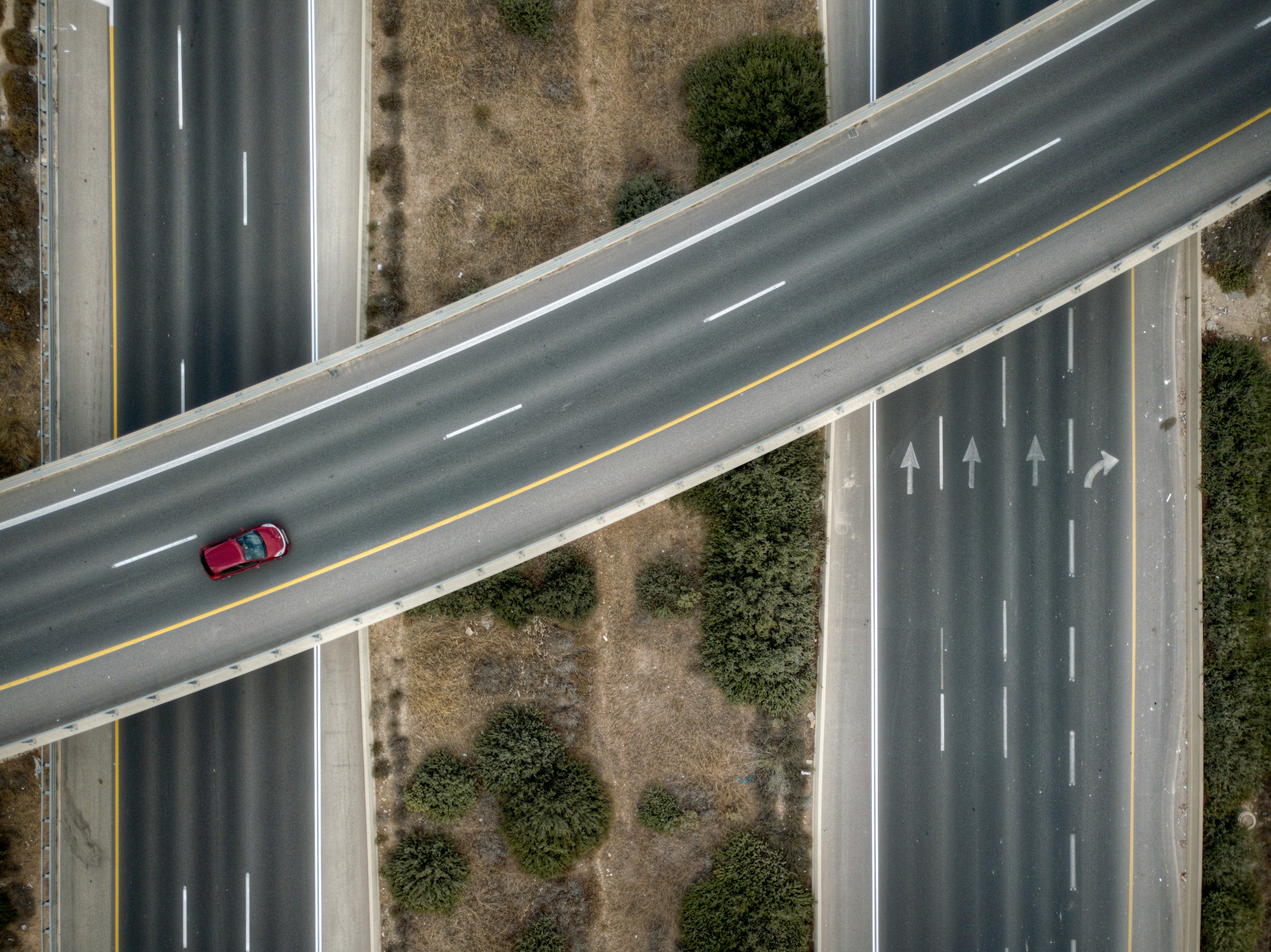 aerial photo of red vehicle on road
