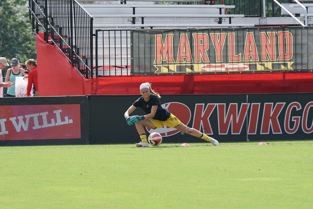 woman in black shirt about to catch a ball during daytime