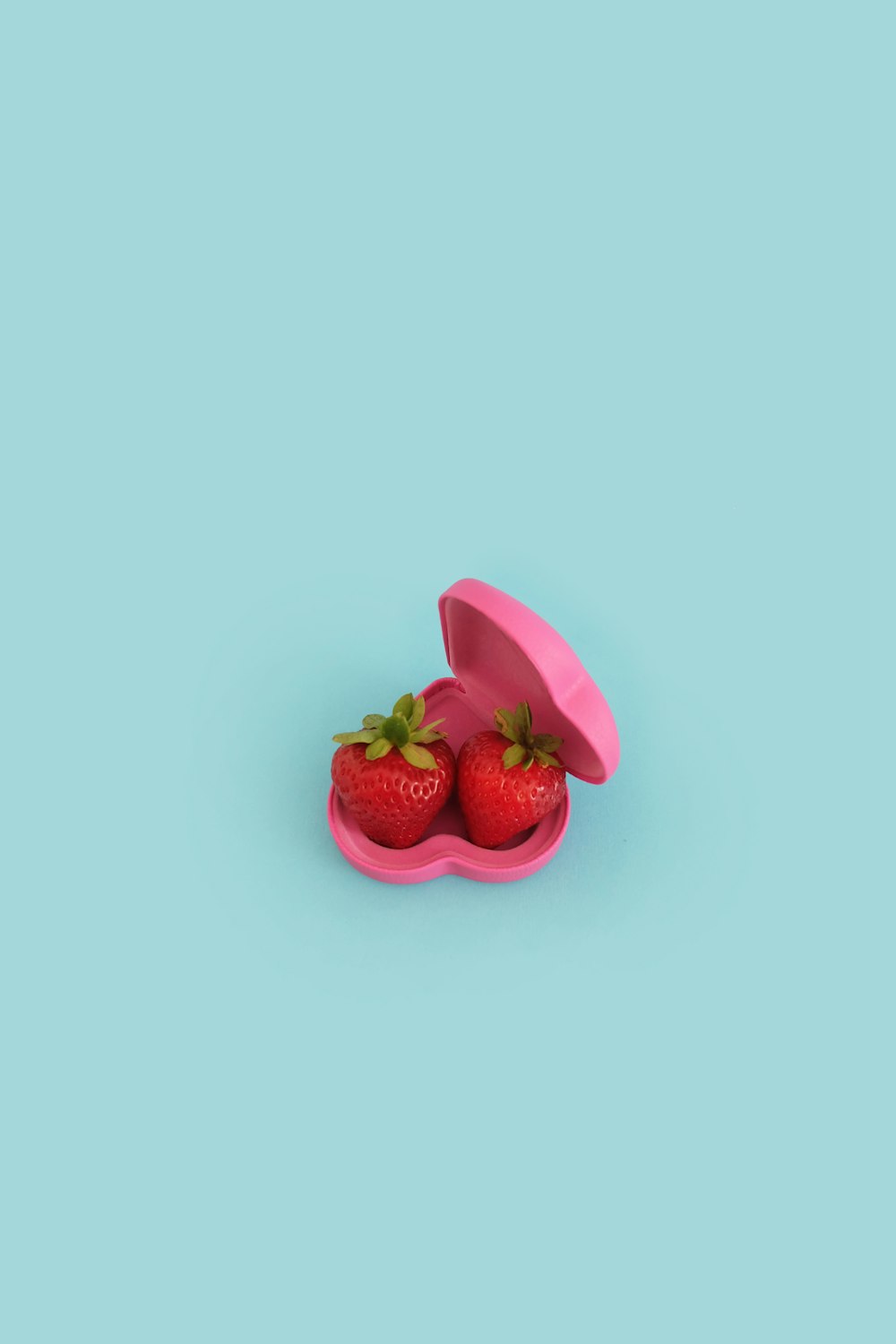 two strawberries on pink case