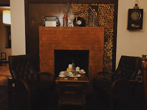 Cozy fireplace corner with two armchairs and a small coffee table.